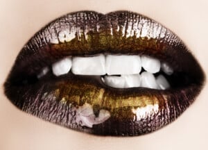 Black gold lips biting.