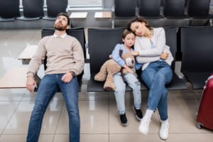 bored man waiting with daughter and wife in airport lounge