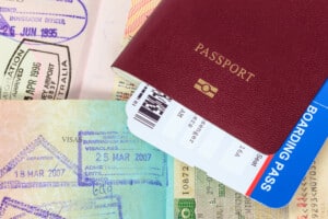 Passport, visa immigration stamps, and boarding pass